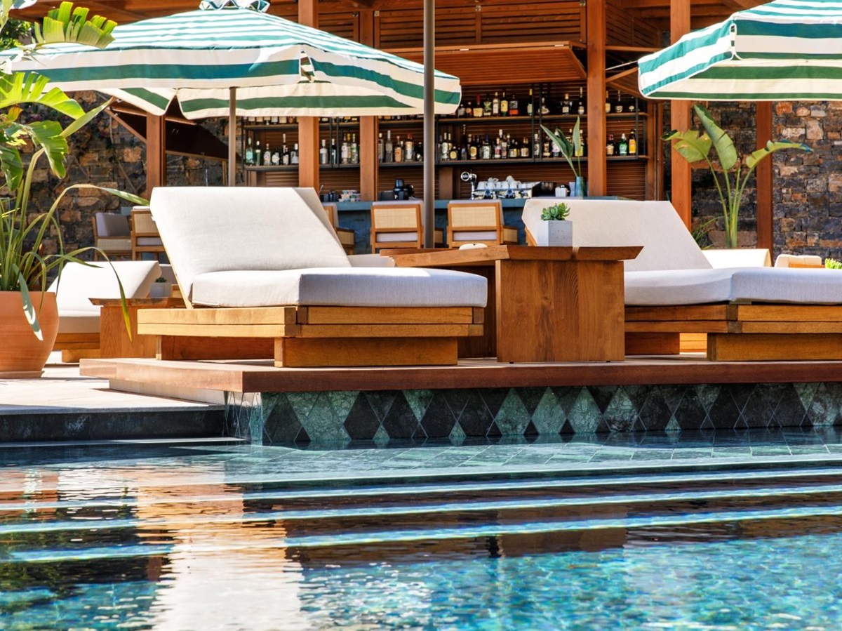 Sun loungers by the pool at luxury resort Daios Cove in Greece