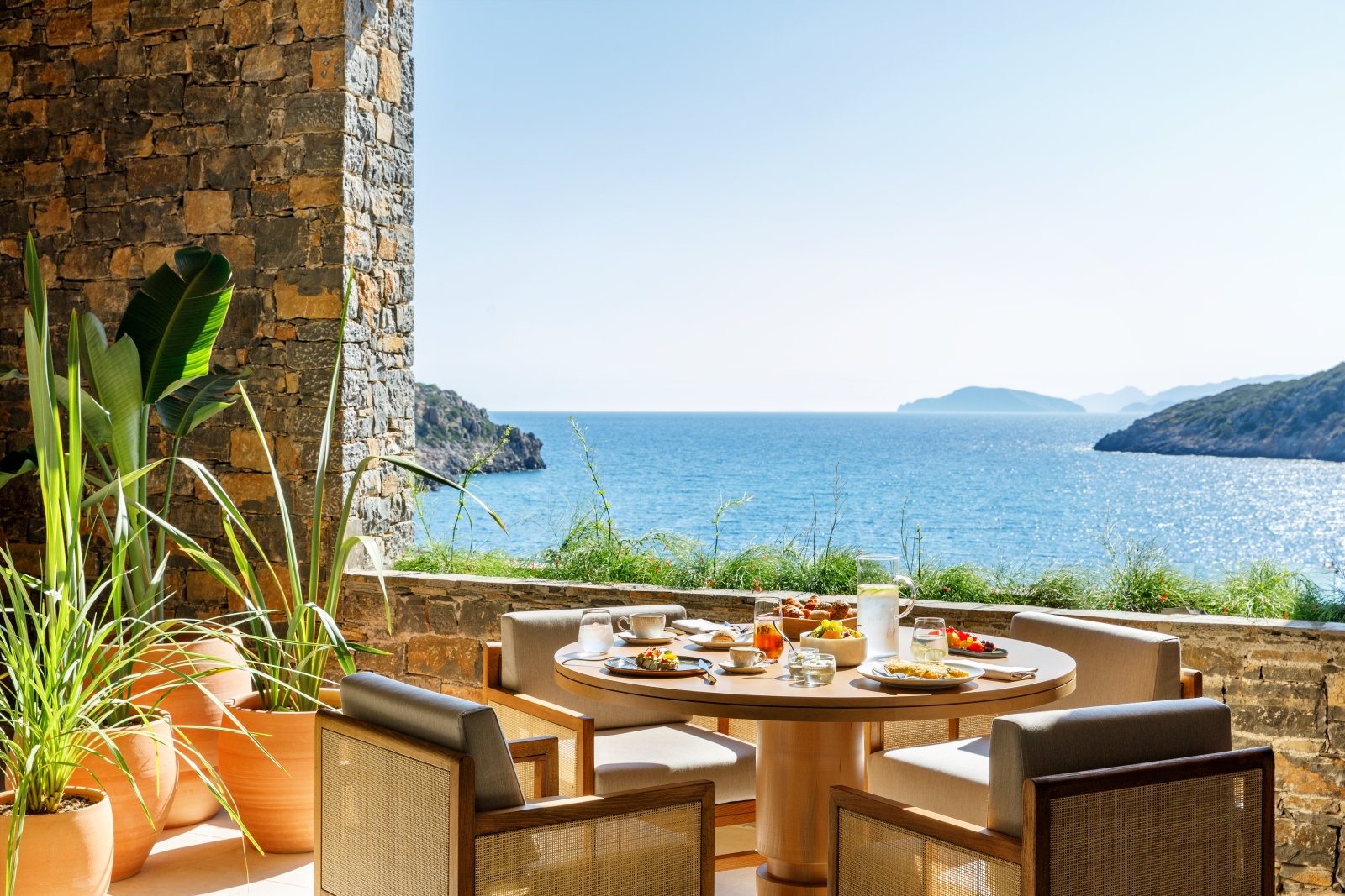 Breakfast on the terrace of Ocean Restaurant with views over the Mediterranean Sea at luxury resort Daios Cove in Greece