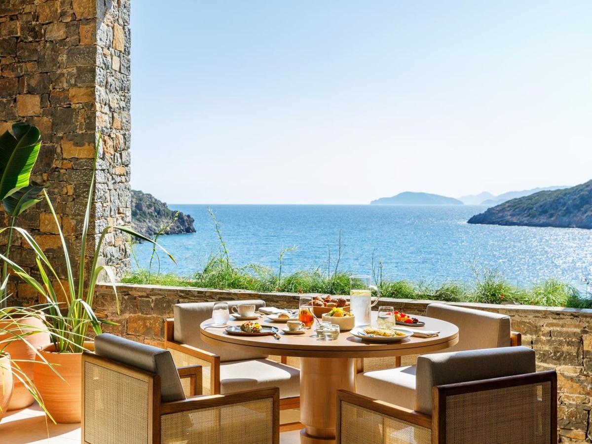 Breakfast on the terrace of Ocean Restaurant with views over the Mediterranean Sea at luxury resort Daios Cove in Greece