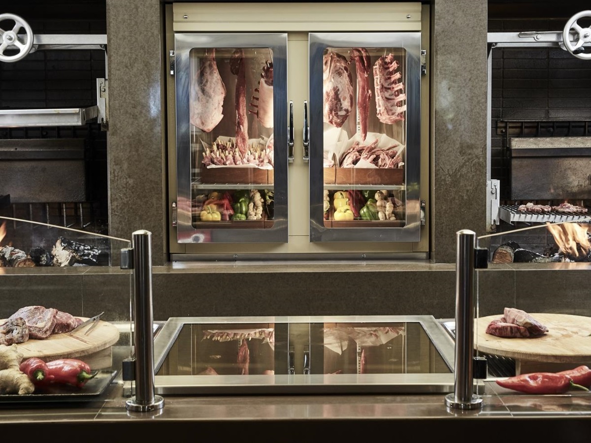 Grill counter with fresh meat at Pangea Restaurant at luxury resort Daios Cove in Greece