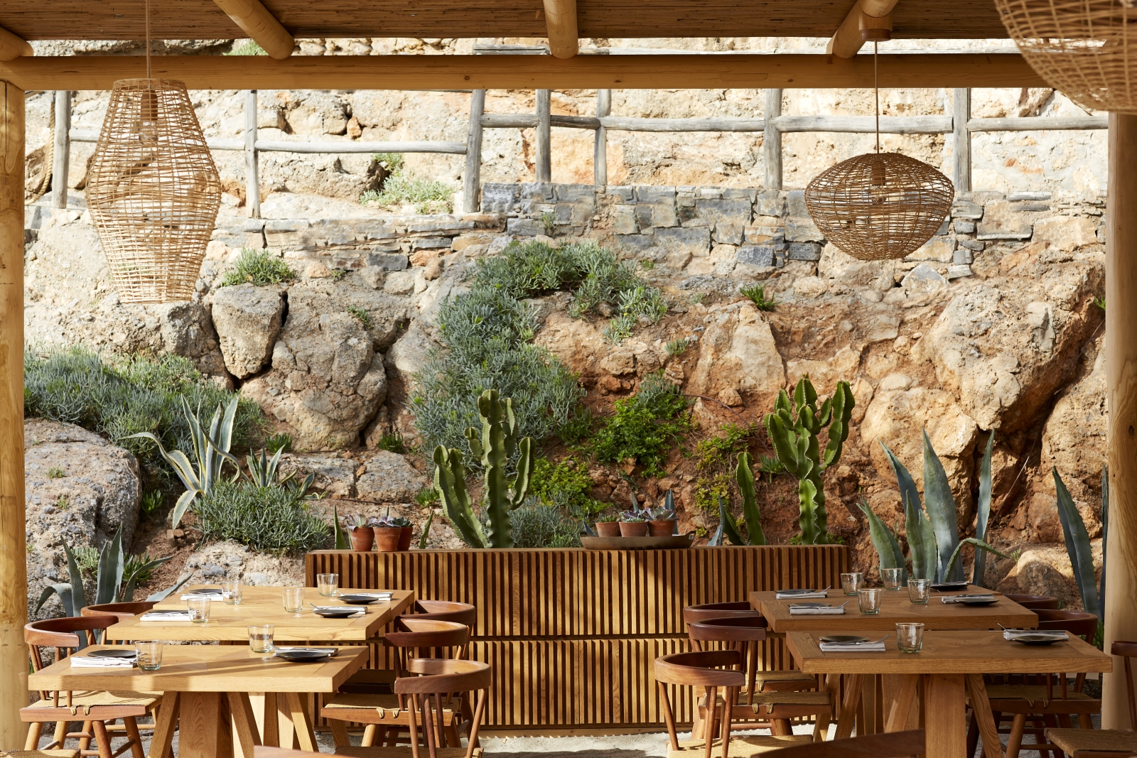 Seating at The Beach House with cacti and other succulents at luxury resort Daios Cove in Greece