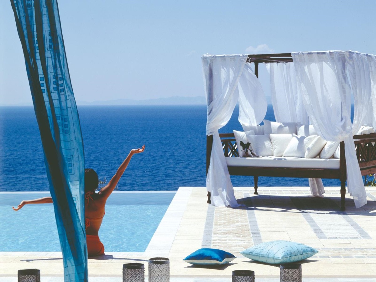 Guest enjoying the pool and sea at luxury resort Danai Beach in Greece