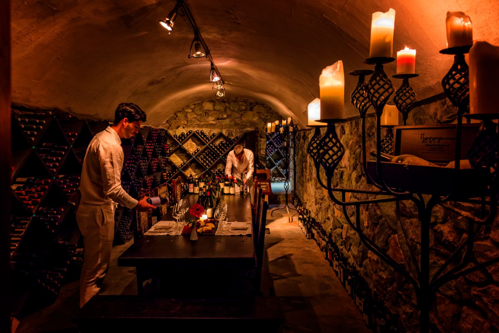 Sommeliers preparing a private meal in the wine cellar at luxury resort Danai Beach in Greece