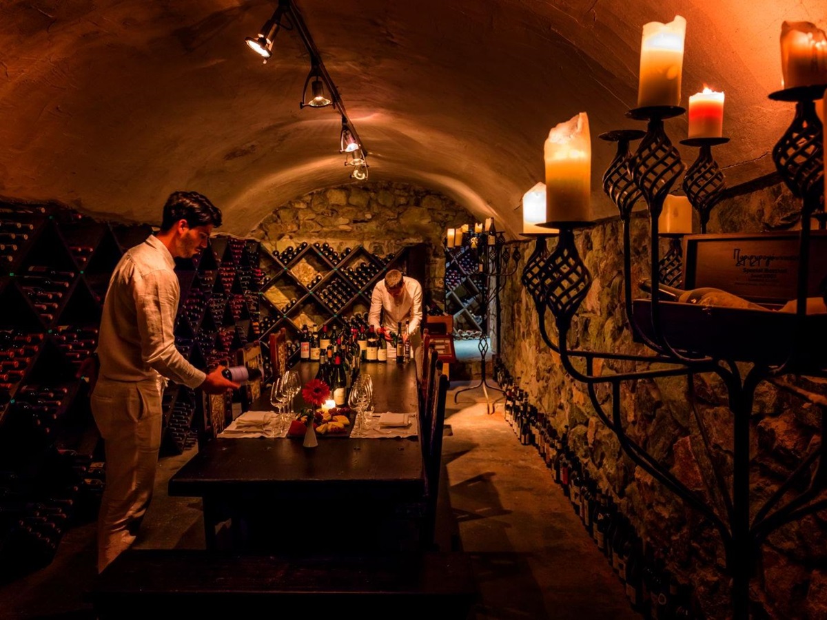Sommeliers preparing a private meal in the wine cellar at luxury resort Danai Beach in Greece