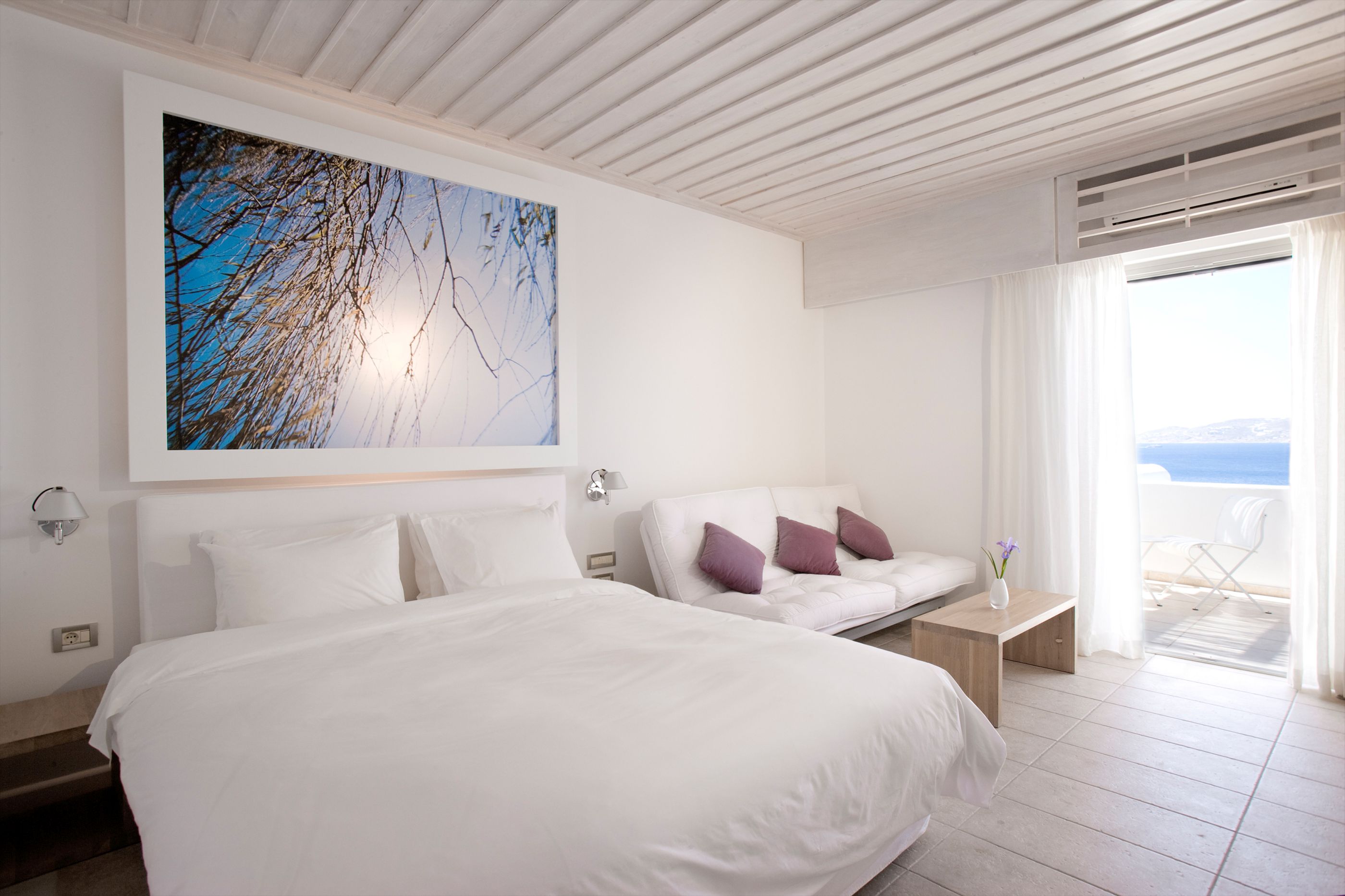 A deluxe room with painting in Grace Mykonos, Greece