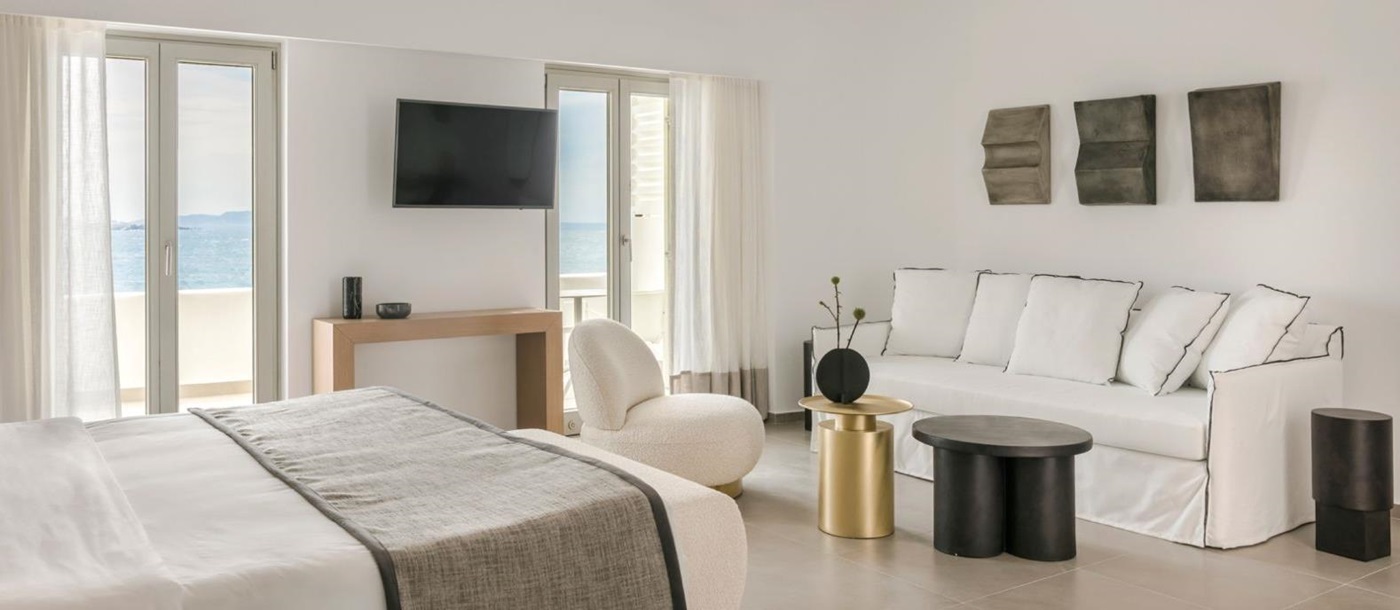 Guest suite bedroom and lounge area at Grace Mykonos