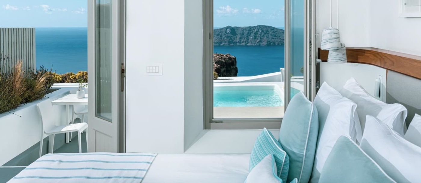 Guest suite with balcony and plunge pool view on the Greek island of Santorini