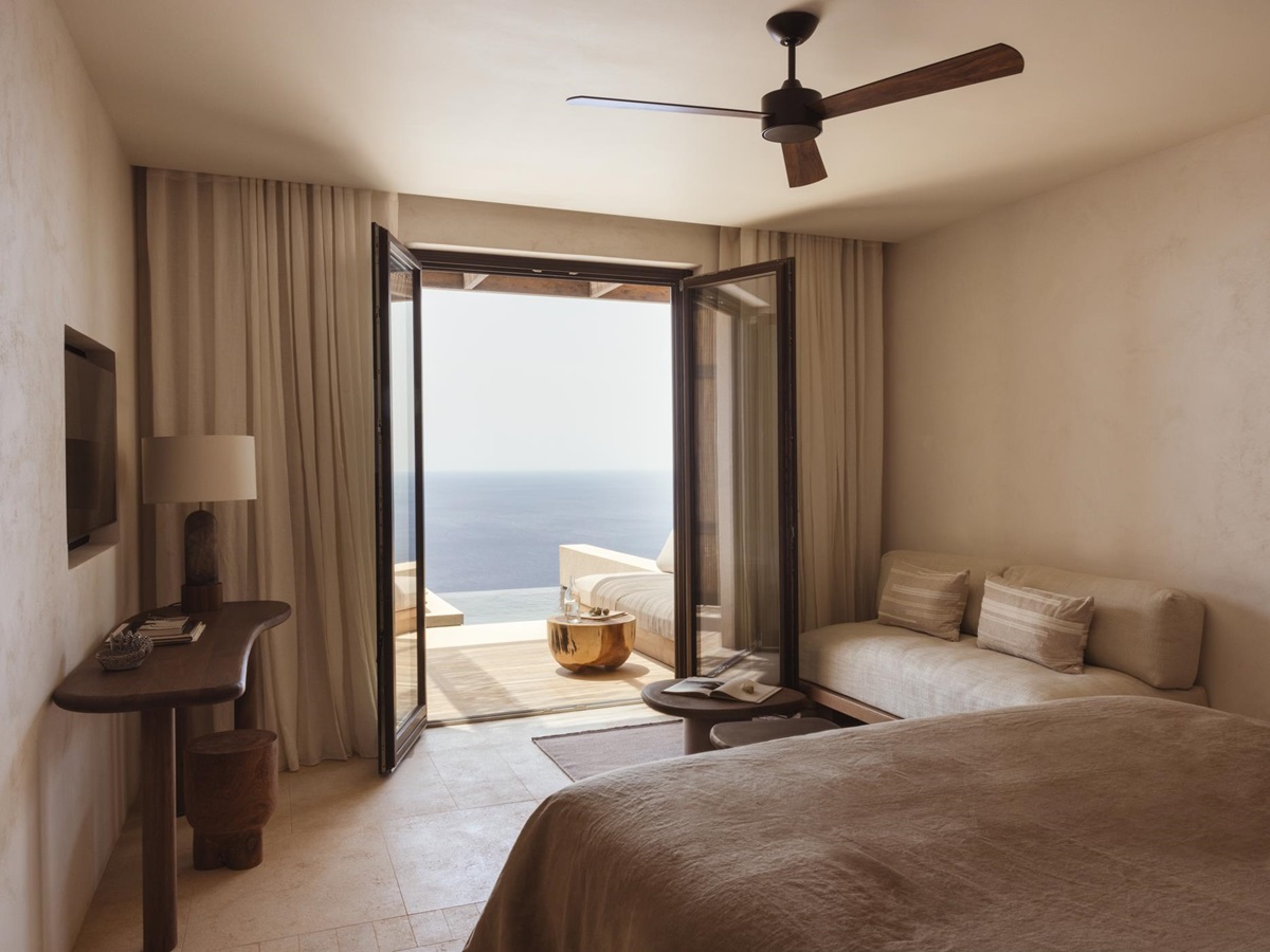 Guest suite bedroom with ocean views at Gundari luxury resort in Greece