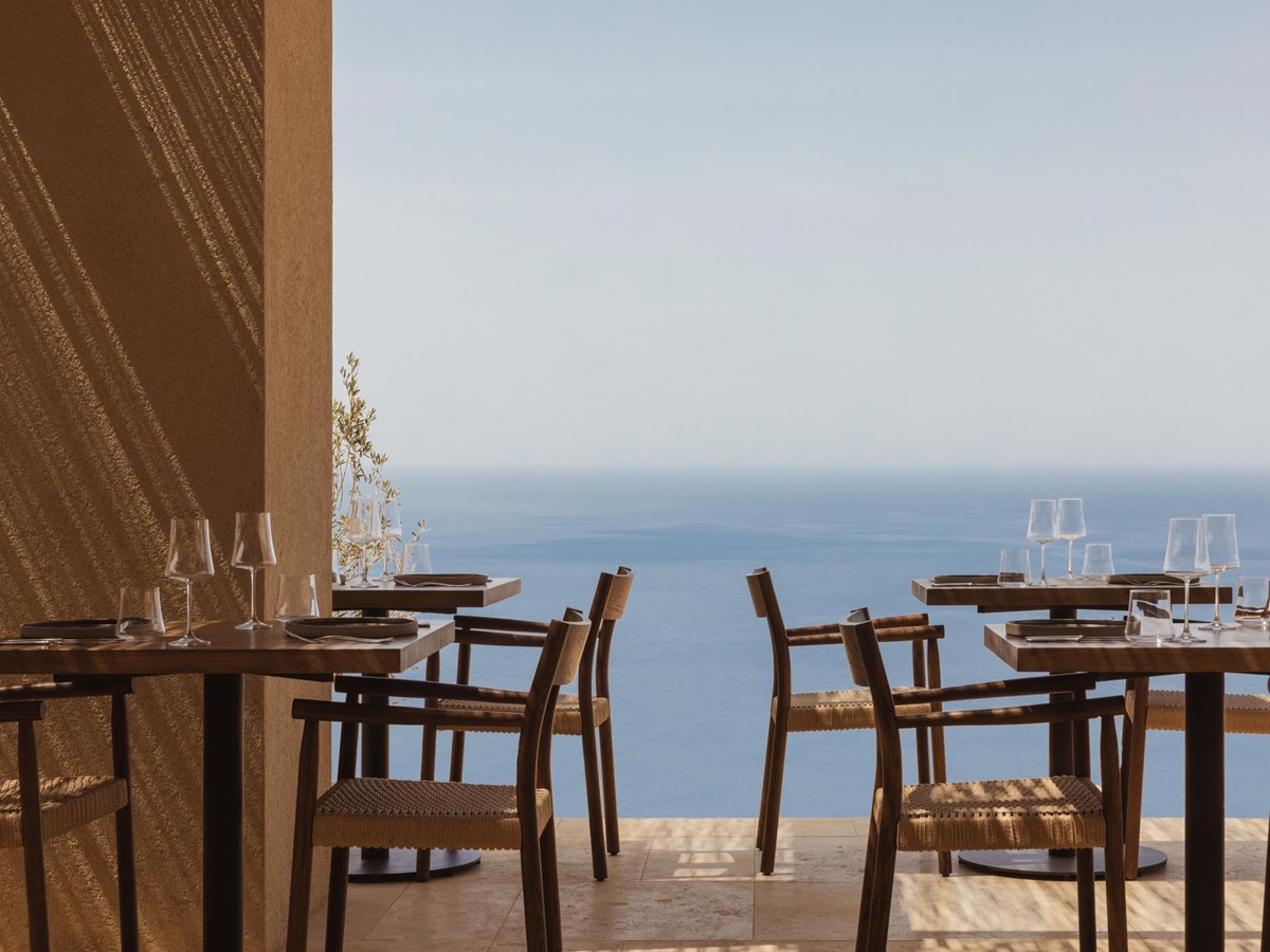 Restaurant tables with ocean views at Gundari luxury resort in Greece