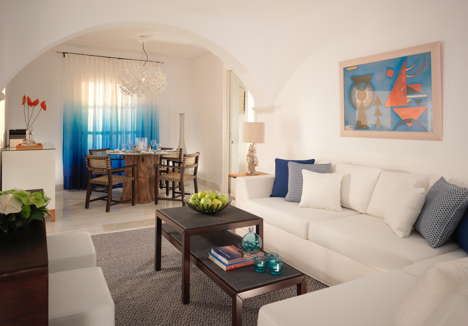Dining and living area of Deluxe Suite at luxury resort Mykonos Grand, Greece