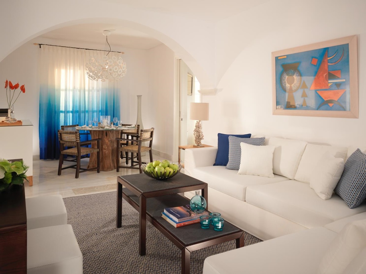 Dining and living area of Deluxe Suite at luxury resort Mykonos Grand, Greece