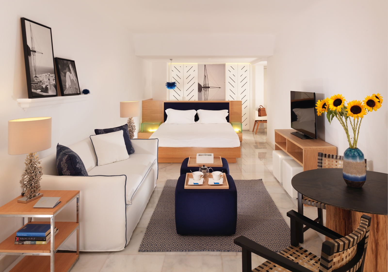 Interior of an open plan suite at luxury resort Mykonos Grand, Greece wtih living area and flat screen tv