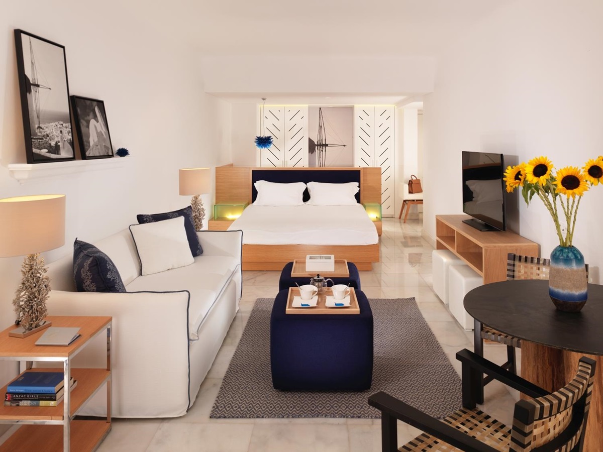 Interior of an open plan suite at luxury resort Mykonos Grand, Greece wtih living area and flat screen tv