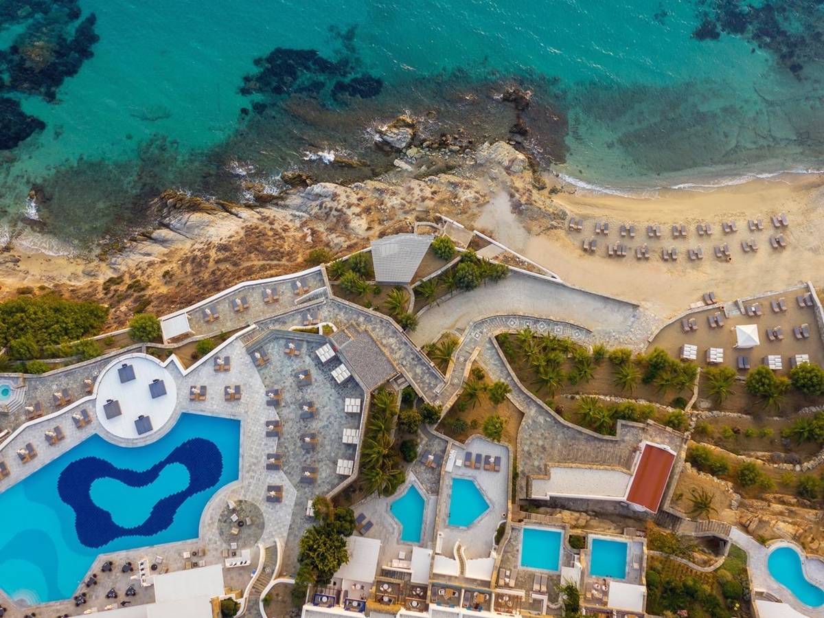 Aerial view over the pools and beach at luxury resort Mykonos Grand, Greece