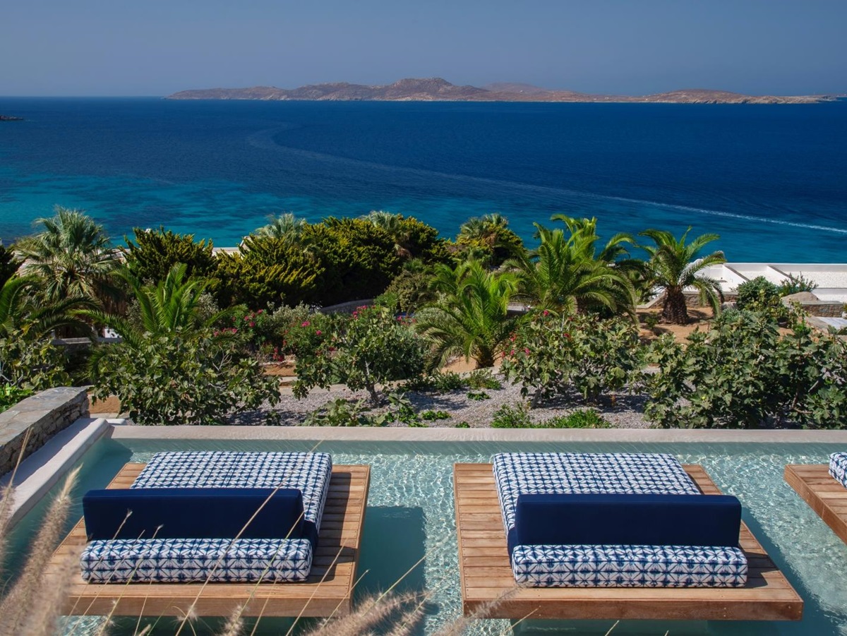 Two sunloungers overlooking the Aegean Sea in the spa pool at luxury resort Mykonos Grand, Greece