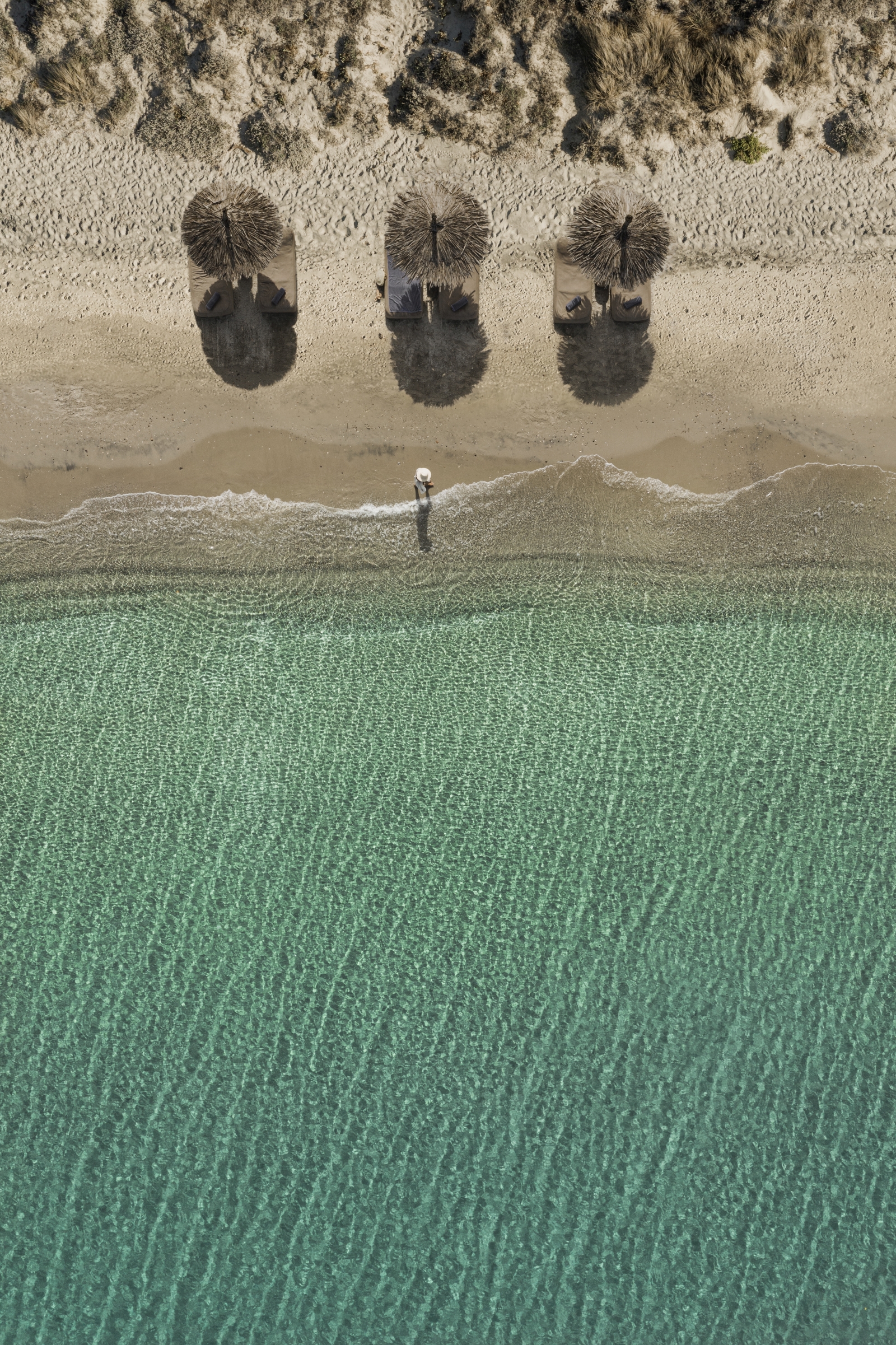 Aerial view of parasols on the beach at luxury hotel OKU Kos in Greece