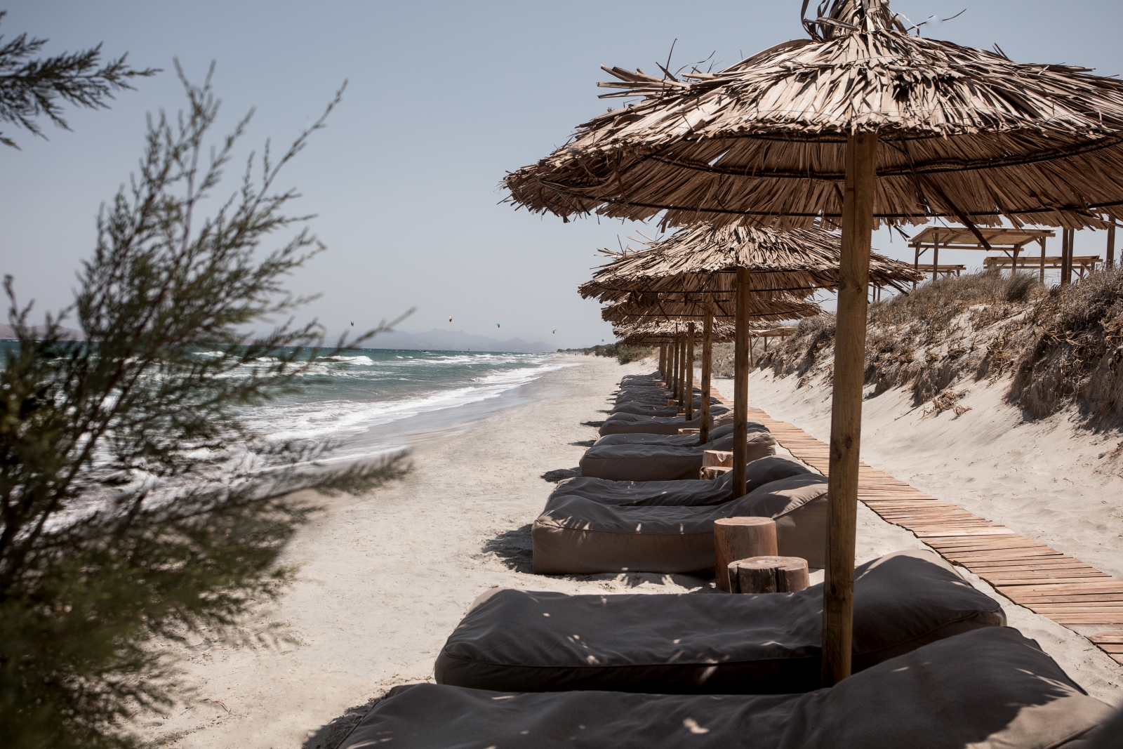 Loungers and parasols on the beach at luxury hotel OKU Kos in Greece