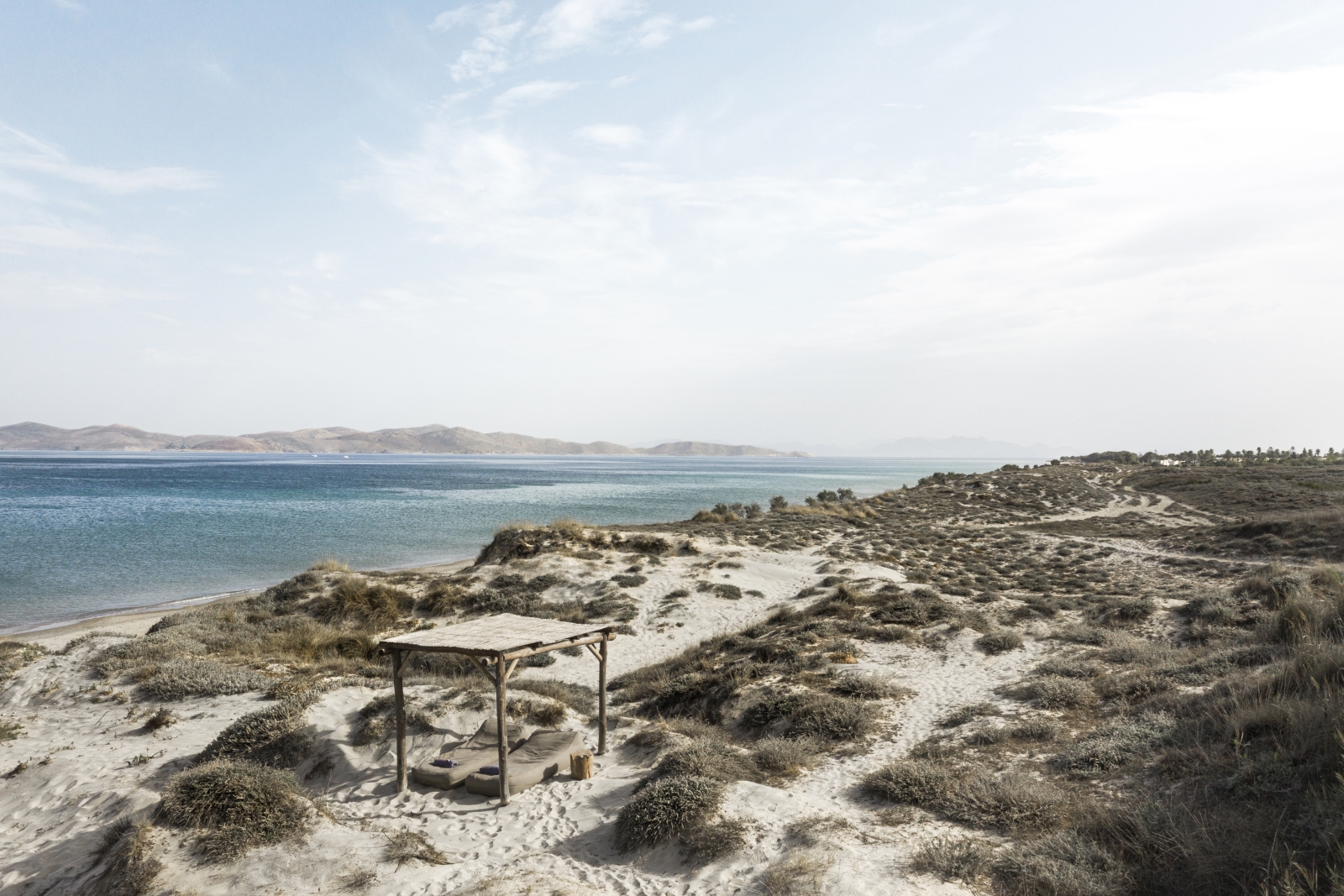 View over a beach cabana and empty beach at luxury hotel OKU Kos in Greece