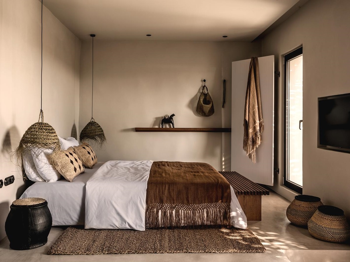 Spacious minimalistic bedroom with earthen colour scheme at luxury hotel OKU Kos in Greece