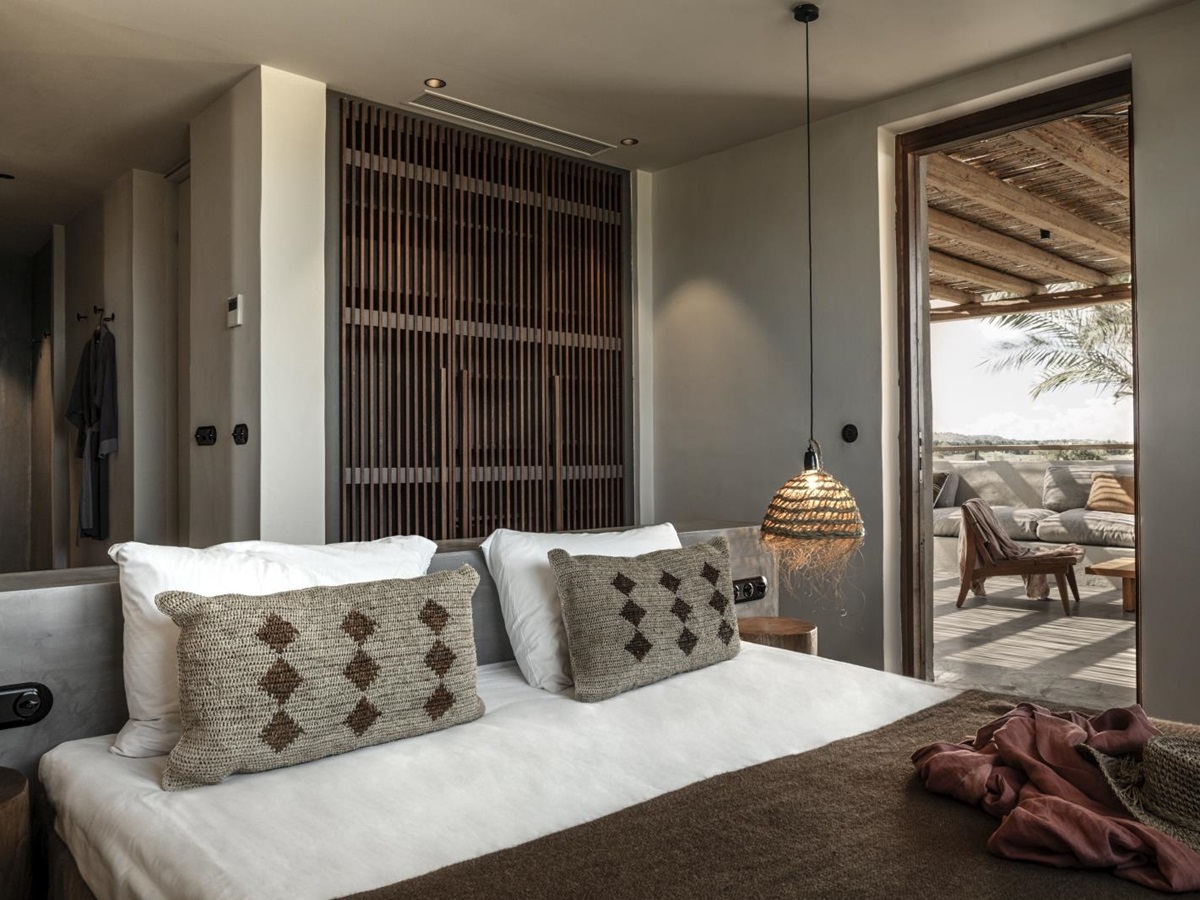 Bedroom with private terrace and earthen colour scheme at luxury hotel OKU Kos in Greece