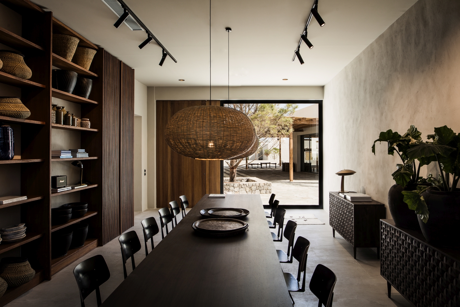 Communal dining table with decor and view over the courtyard at luxury hotel OKU Kos in Greece