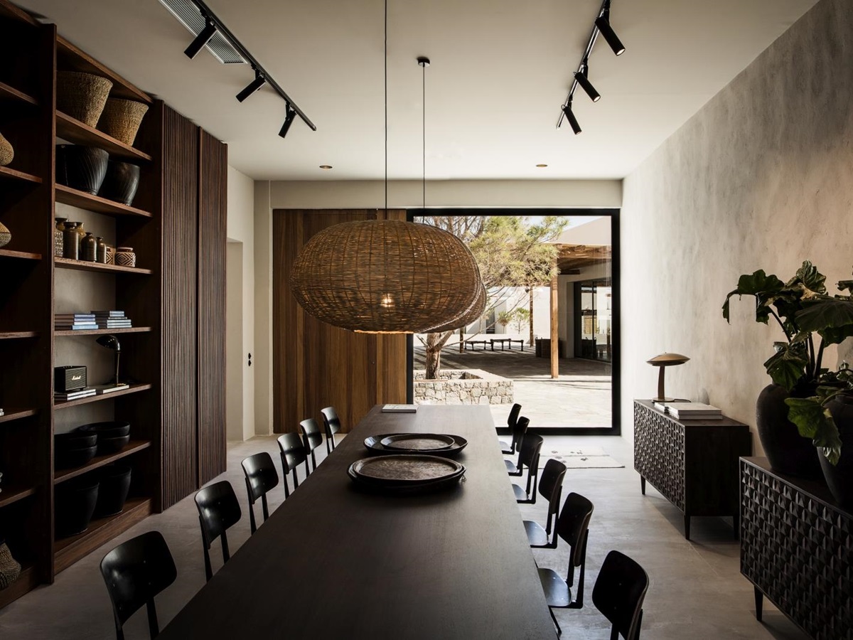 Communal dining table with decor and view over the courtyard at luxury hotel OKU Kos in Greece