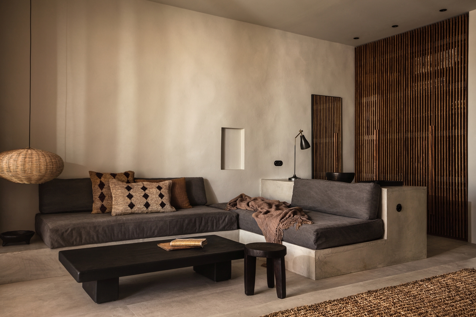 Lounge of a suite with minimalistic earthen decor at luxury hotel OKU Kos in Greece