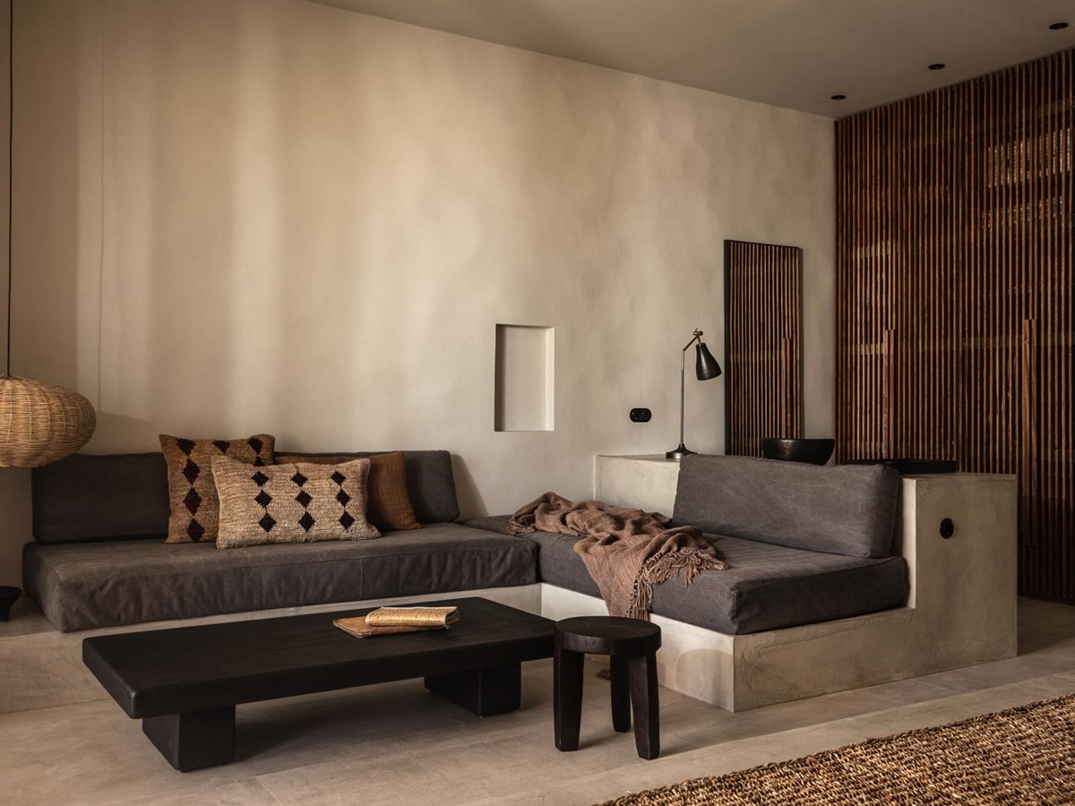 Lounge of a suite with minimalistic earthen decor at luxury hotel OKU Kos in Greece
