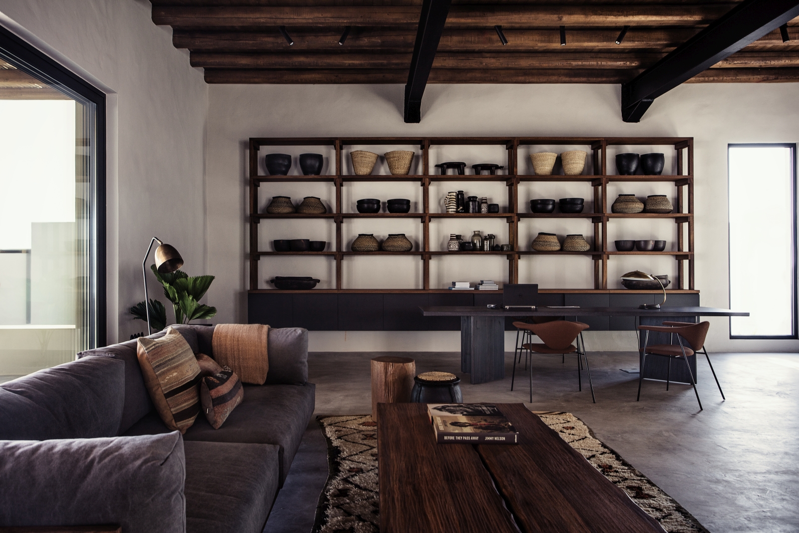 Lounge with working space, seating area and rustic decor at luxury hotel OKU Kos in Greece