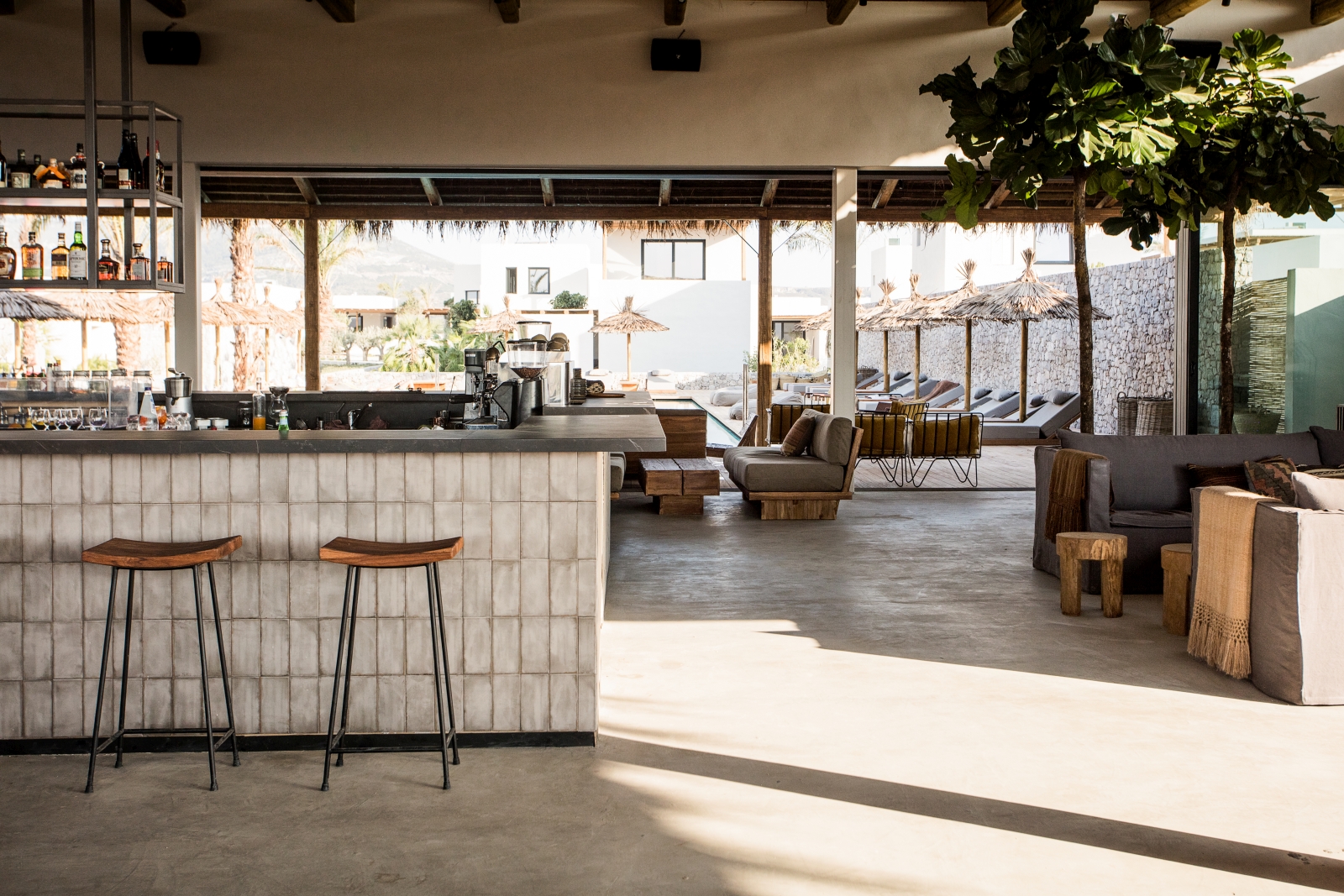 Main lounge and bar area at luxury hotel OKU Kos in Greece with views over the pool