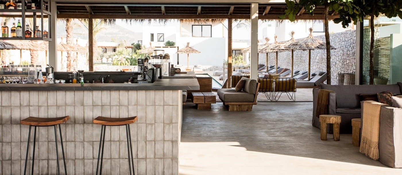 Main lounge and bar area at luxury hotel OKU Kos in Greece with views over the pool
