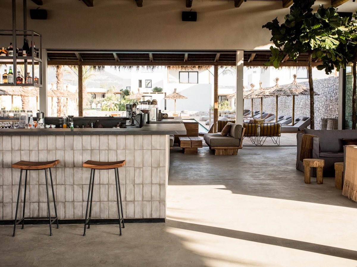 Main lounge and bar area at luxury hotel OKU Kos in Greece with views over the pool