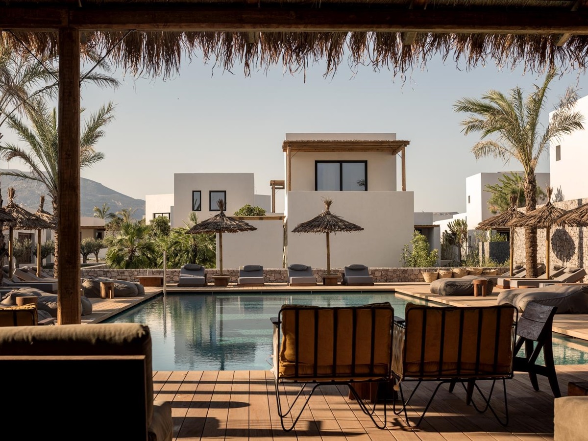 Pool with plenty of seating, loungers and parasols at luxury hotel OKU Kos in Greece