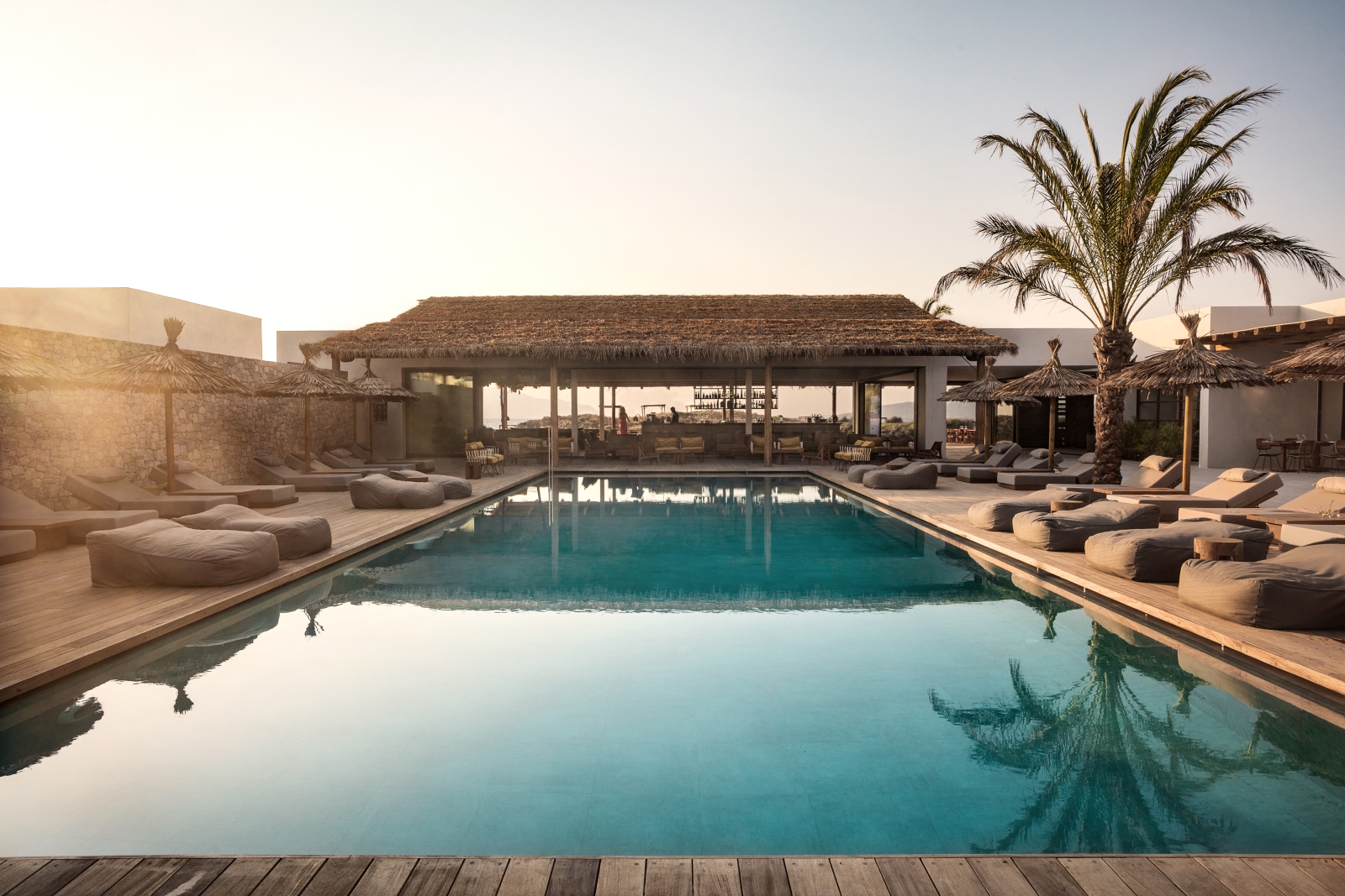 View over the pool and loungers into the bar area at luxury hotel OKU Kos in Greece