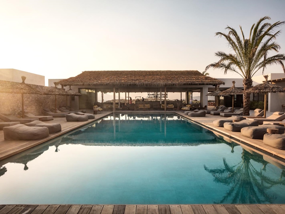 View over the pool and loungers into the bar area at luxury hotel OKU Kos in Greece