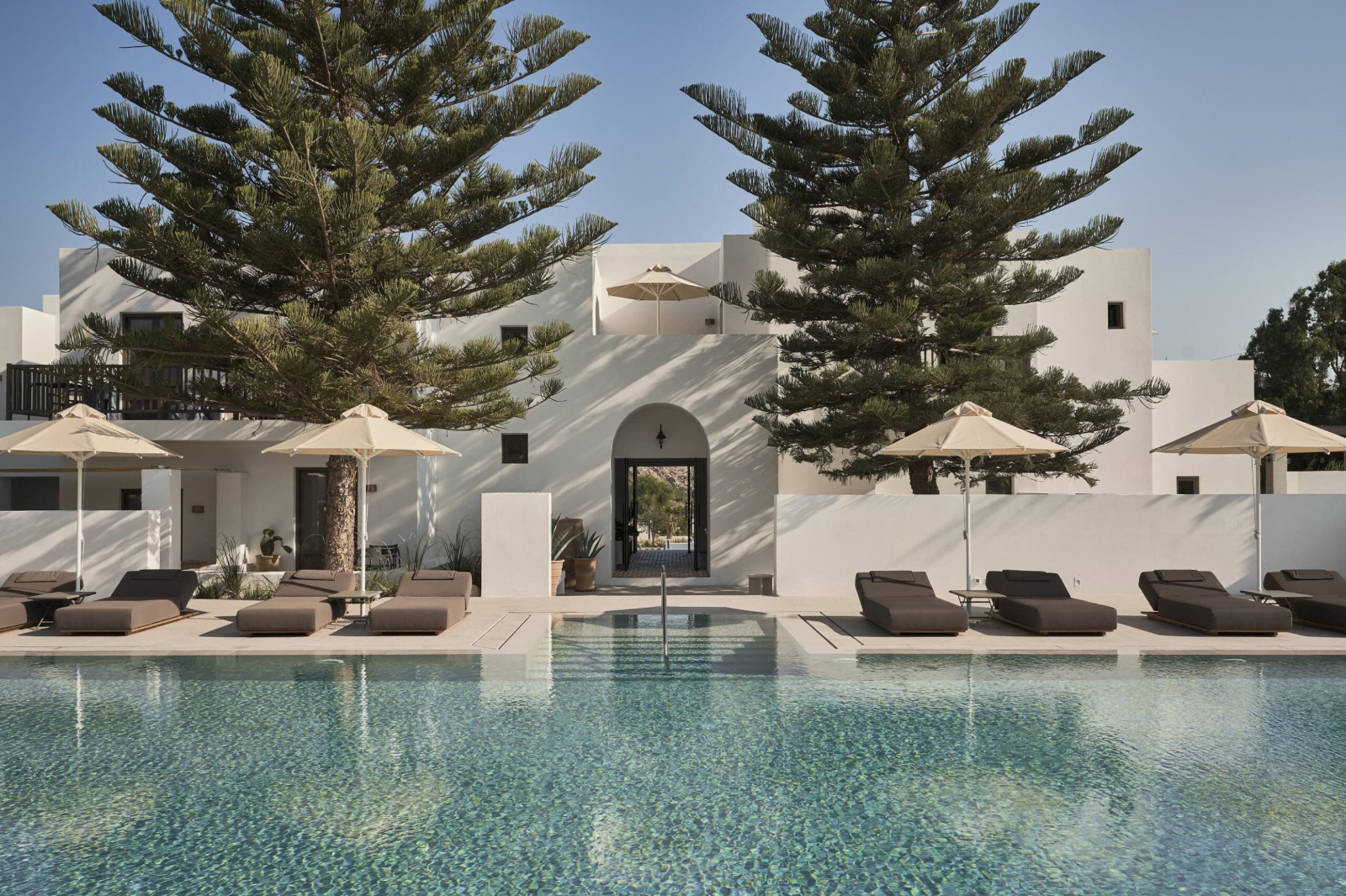 Pool and terrace with loungers at Parilio Hotel Paros