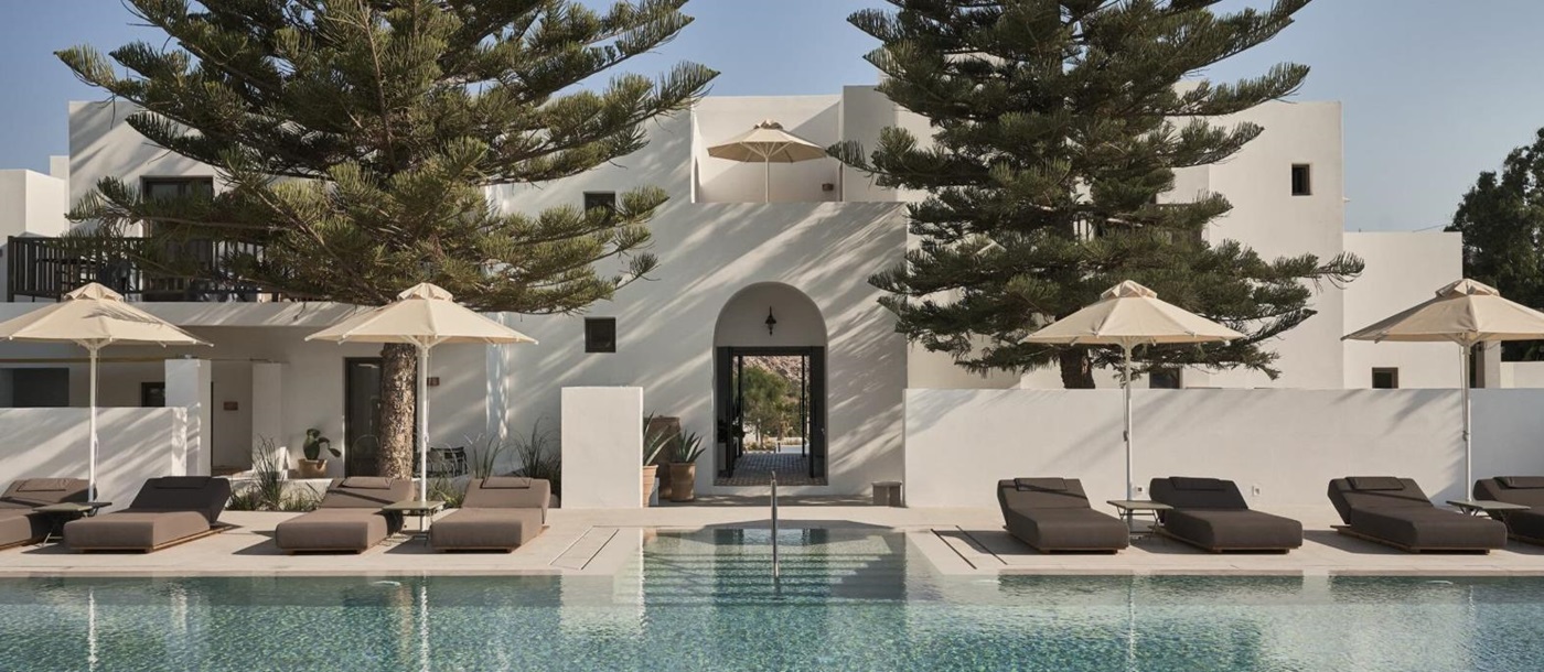 Pool and terrace with loungers at Parilio Hotel Paros