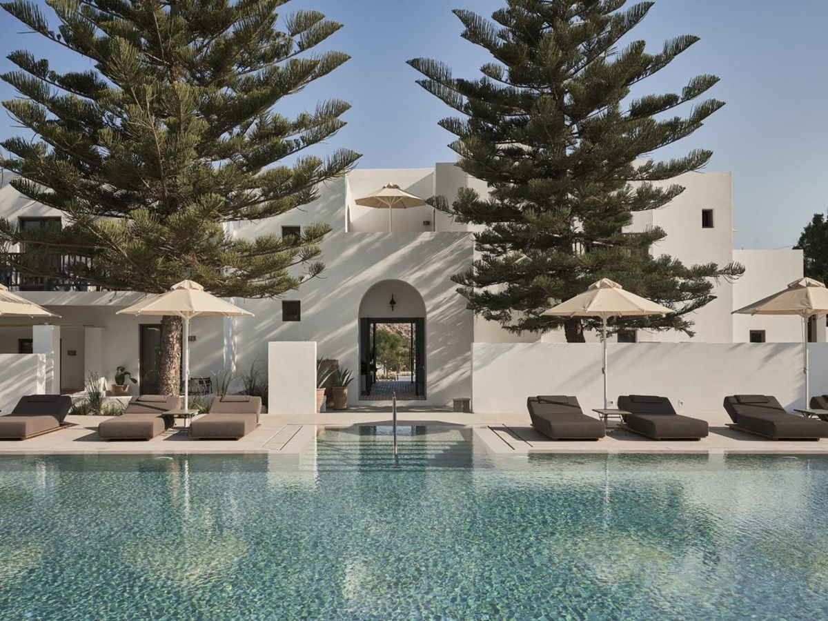 Pool and terrace with loungers at Parilio Hotel Paros