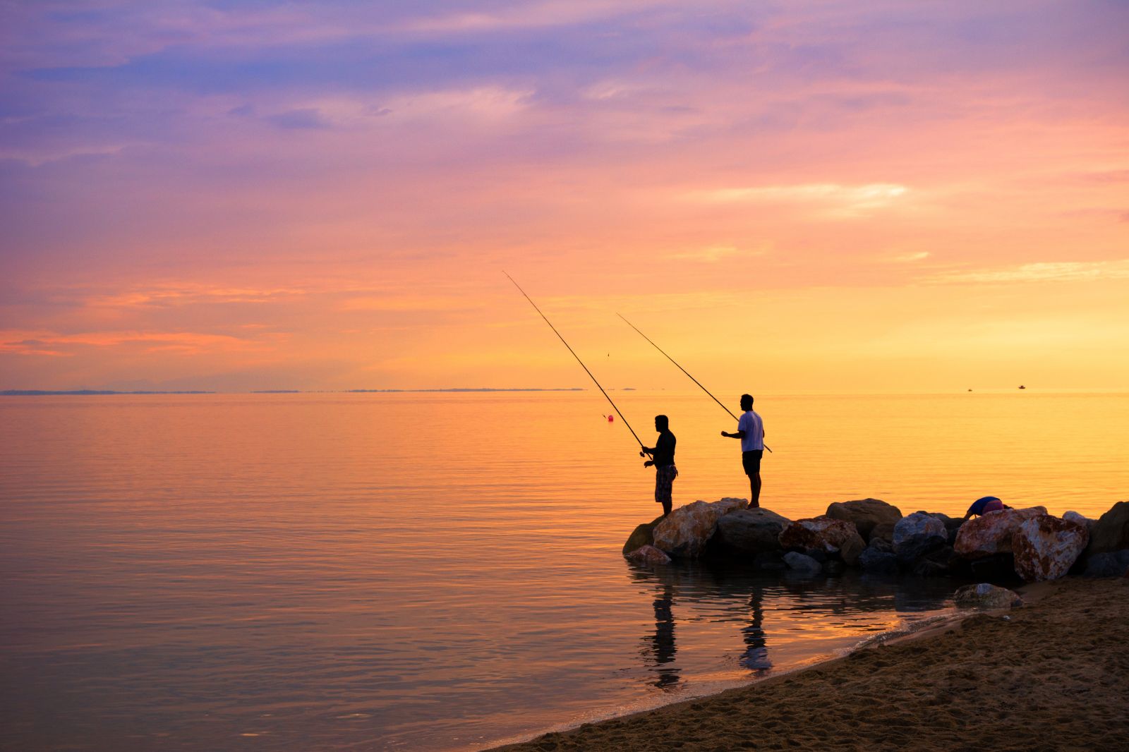 Fishermen at sunset in the Aegean, Greece