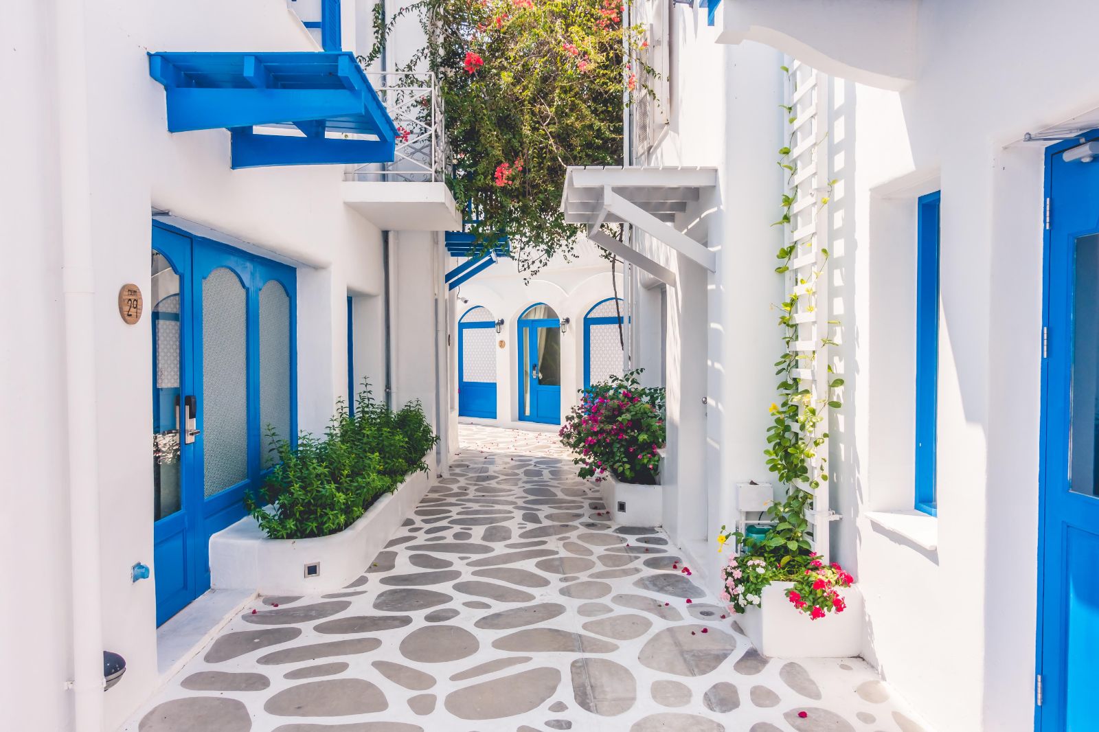 Narrow street with white and blue houses in the Greek islands
