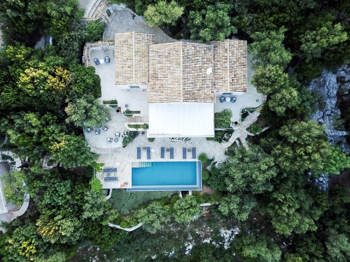 View of the roof and pool at villa apraos in corfu, Greece from above surrounded by trees