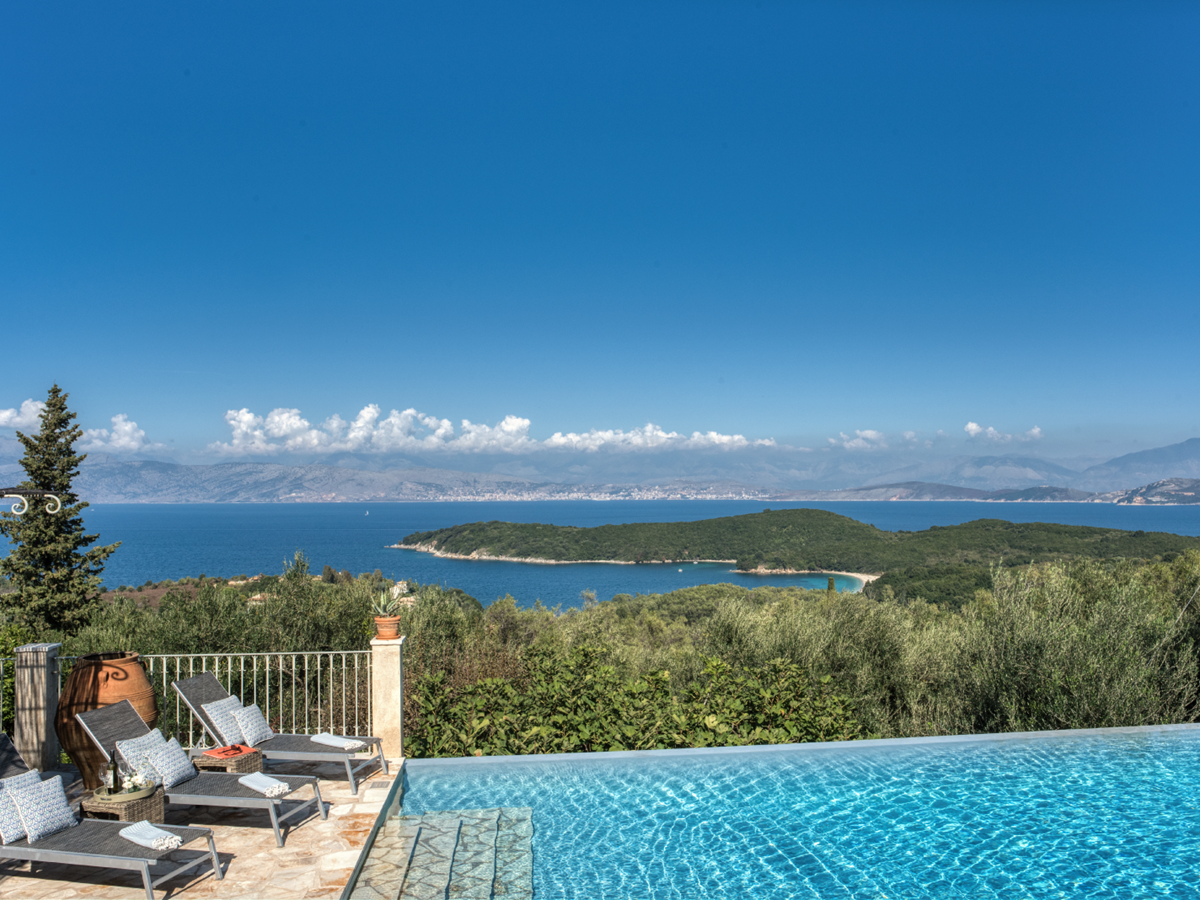 Infinity pool, sun loungers and sea view at Eremitis on Corfu, Greece