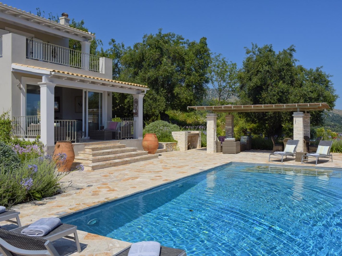 Pool, patio, covered dining area and villa at Eremitis on Corfu, Greece