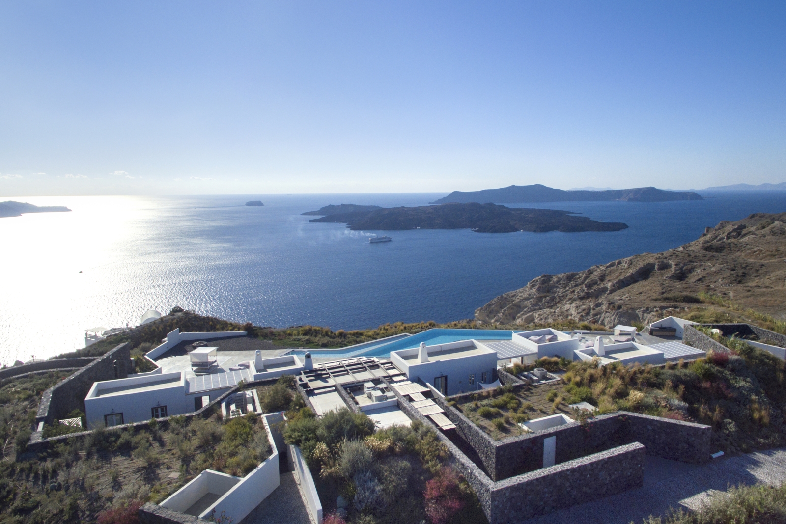 Aerial view of villa, its surroundings, and the sea at Erosantorini on Santorini, Greece