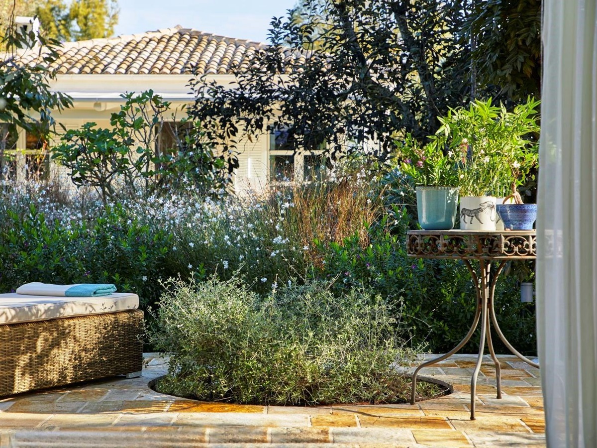 garden with stone terrace at kogevina beach villa in corfu, greece