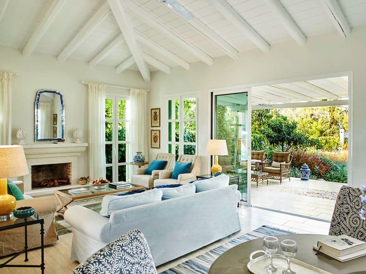 white sofa, table and chairs in living room at kogevina beach villa in corfu, greece