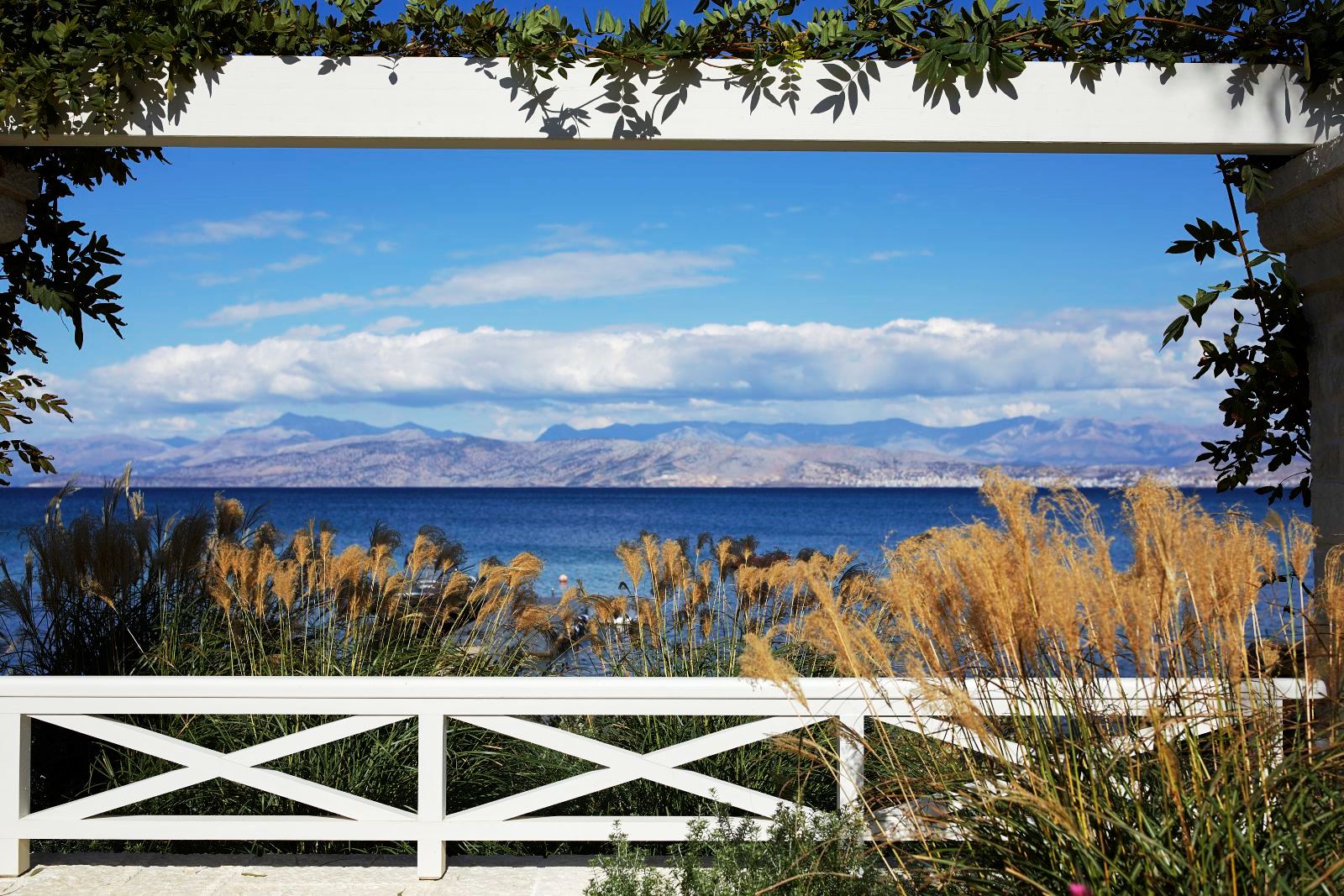view over the sea with hills in the distance from kogevina beach villa in corfu, greece