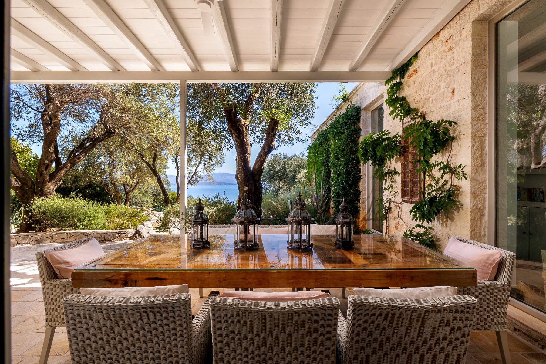 Covered terrace with dining table at Thinali, Corfu