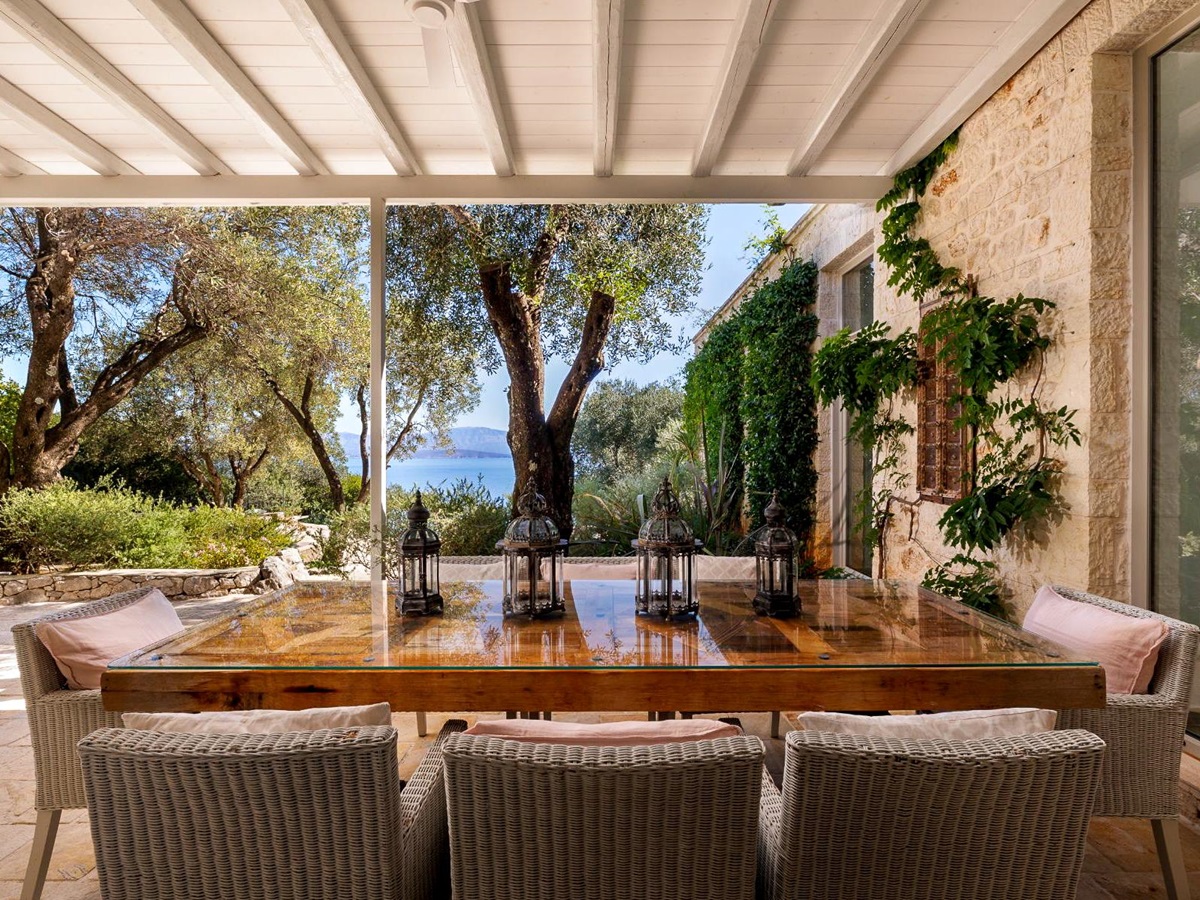 Covered terrace with dining table at Thinali, Corfu