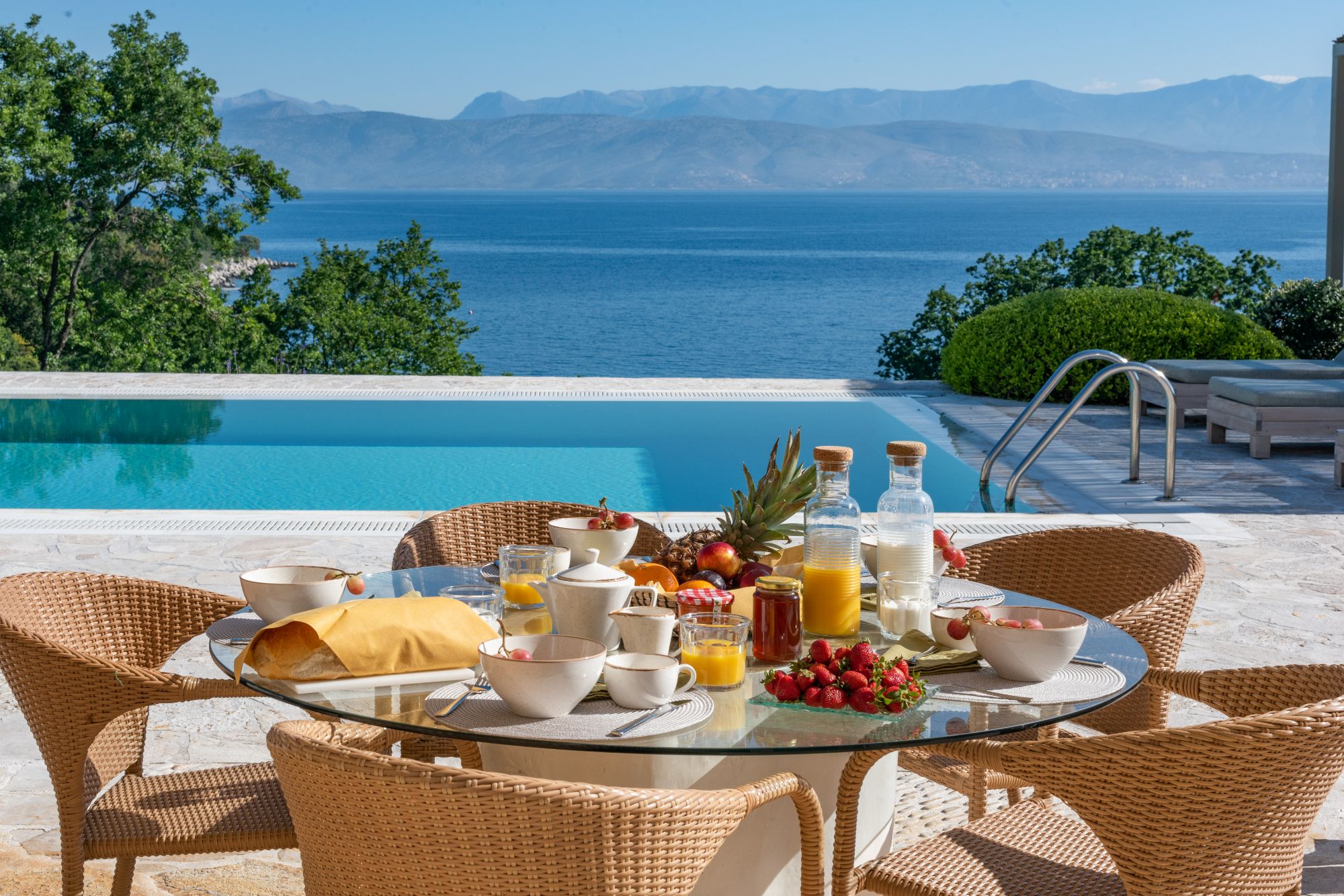 Pool with outdoor dining at Villa Anthi
